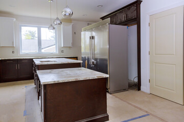 Installing cabinets, countertop in a kitchen with appliances