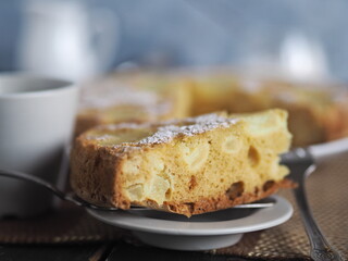 Home cooking.Sponge cake with pineapple on a dark background.