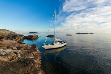 Sailboat moored to barren rock in Stockholm archipelago