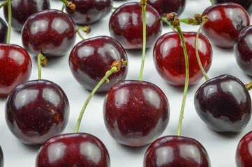 Cherries collection. Ordered red organic ripe cherries on a white background close up