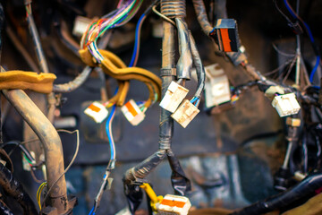 Close up of the engine control unit of the car, multicolored wires plug, contacts - a wiring of a truck car. Electrical communication, wires in an old car