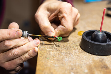 The technical process of creating a mold ring by a jeweler worker