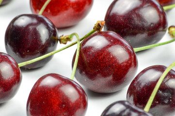Cherries collection. Ordered red organic ripe cherries on a white background close up