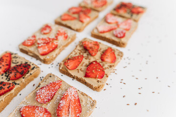 toast bread with peanut paste and strawberries