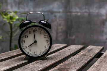 Black Alarm Clock on wood table