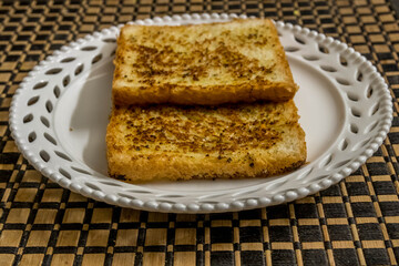 Garlic bread toasted being served in a plate