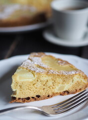 Home cooking.Sponge cake with pineapple on a dark background.