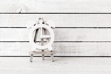 White Alarm Clock Shaped with wood art stand on white wood Background