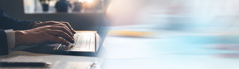 
Businessman working on laptop keyboard. Panoramic business banner with copy space.
