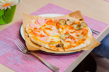 Children's pizza for a festive lunch. Table setting for one kid
