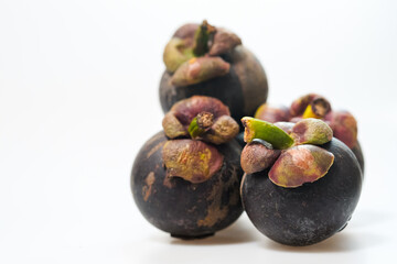 mangosteen fruits placed on a white background
