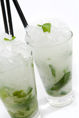 Mojito Rum cocktail on white background in highball tumbler.