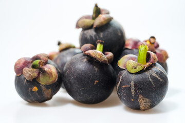 mangosteen fruits placed on a white background