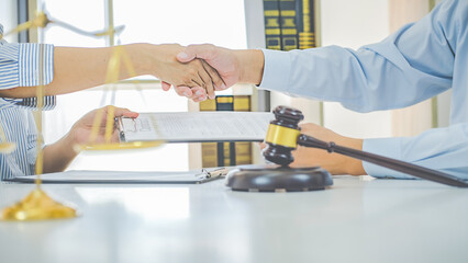 Judge gavel with Justice lawyers having team meeting at law firm background. Concepts of Law and Legal services.