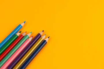 Color pencils close-up on color and white paper