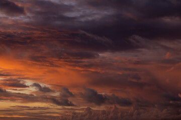 Fototapeta na wymiar Dramatic sunset sky with orange clouds. Golden clouds in the sky.