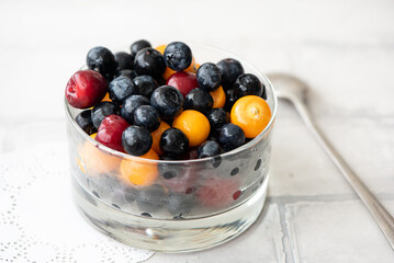 fresh blueberries, physalis and cherry in a beautiful bowl