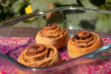 Cinnamon roll and nature with flowers in the background