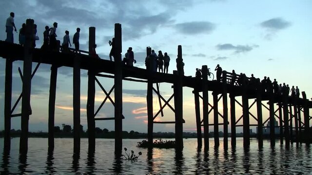 Sunset at U Bein, the longest teak bridge in the world, located in Amarapura, near the city of Mandaly. It is one of the biggest tourist attractions in Myanmar.