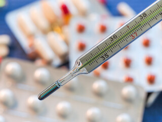 Mercury thermometer and pills.