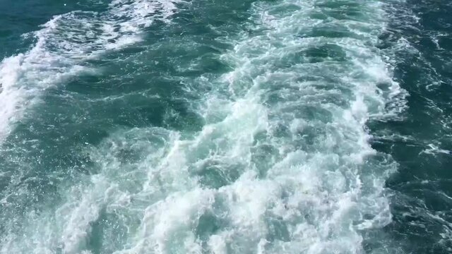 Stern Ferry. Trail on water surface behind of fast moving motor boat ferry