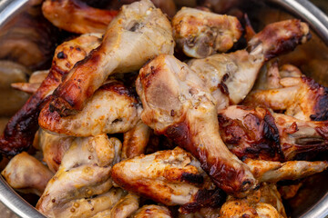 Juicy grilled chicken legs and wings. Close-up.