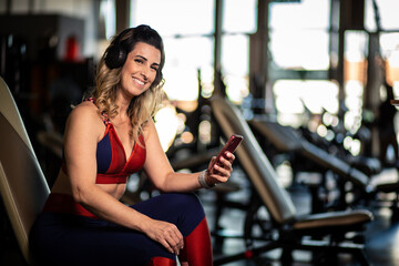 Happy fitness woman in gym