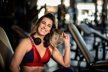Happy fitness woman in gym