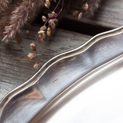 vintage swedish metal tray in scandinavian style on a wooden table with dried flowers