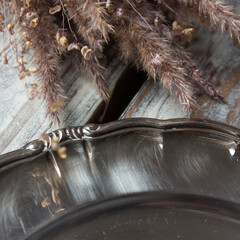 vintage swedish metal tray in scandinavian style on a wooden table with dried flowers