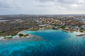 Aerial view of coast of Curacao in the Caribbean Sea with turquoise water, cliff, beach and beautiful coral reef