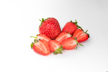 lots of red strawberries and chopped strawberries