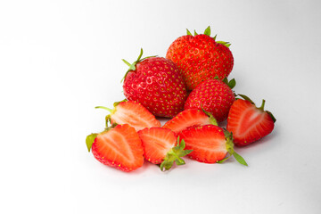 lots of red strawberries and chopped strawberries
