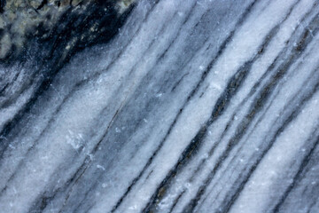 Raw natural striped marble with a background texture pattern.