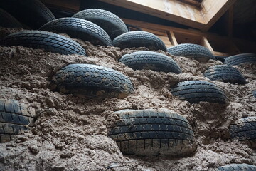 Rammed Earth Tire Wall that is the foundation for an Earthship. Taos, New Mexico. December 2019