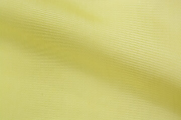 Light yellow plain fabric, background, close-up