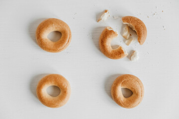 Drying or mini round bagels on a white wooden background. Top view. Copy, empty space for text