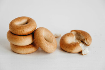 Drying or mini round bagels on a white wooden background. Copy, empty space for text