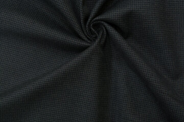 Dark woolen gray fabric in a small pattern, background, wool. Fabric Texture In Dark Gray