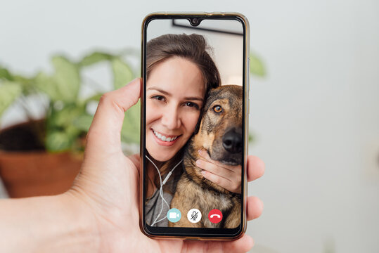 picture of call screen of woman making a video call next to her brown dog