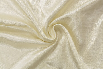 Silk fabric. Light artificial shiny fabric of ivory color, background, silk, satin