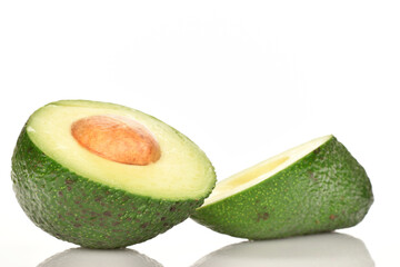 Green fresh ripe tasty avocado, close-up, on a white background.