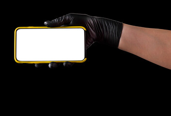 Hand in black glove holding mobile phone with blank screen isolated on black
