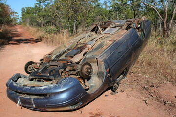 Car Flipped over in the middle of a dirt road with all wheels taken off in Northern Territory Australia, 2017