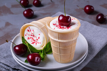 Creamy ice cream topped with sublimated berry powder in waffle cup cones