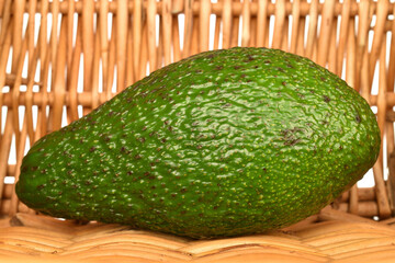 Green fresh ripe tasty avocado, close-up, on a white background.