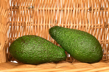 Green fresh ripe tasty avocado, close-up, on a white background.