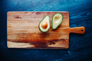Multiple avocado on wooden plate