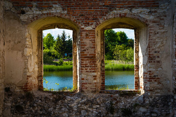Two old windows in the castle ruins with a beautiful view of Polish lands.