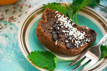 Pieces chocolate cake on a white plate with mint